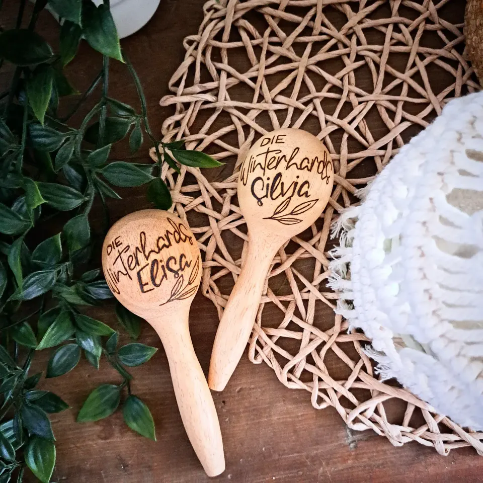 Two wooden rattles with names and a heart